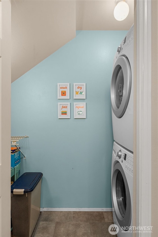 23501 112th Ave SE Unit F103, Kent, WA 98031 - laundry area featuring stacked washer / drying machine and baseboards