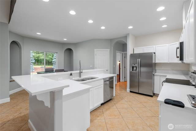 10 Legacy Ln, Elma, WA 98541 - kitchen featuring stainless steel appliances, arched walkways, light countertops, light tile patterned flooring, and recessed lighting