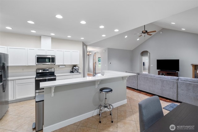 10 Legacy Ln, Elma, WA 98541 - kitchen featuring stainless steel appliances, arched walkways, light tile patterned floors, open floor plan, and recessed lighting