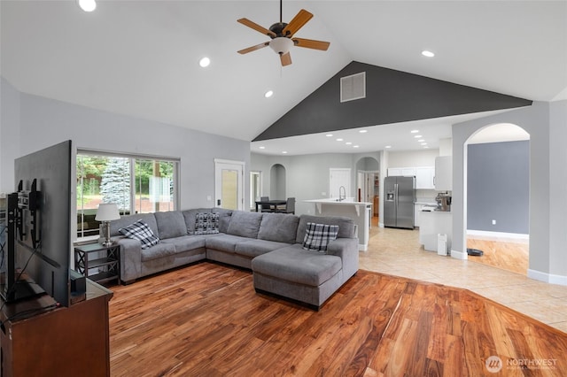 10 Legacy Ln, Elma, WA 98541 - living room with arched walkways, high vaulted ceiling, light wood-type flooring, a ceiling fan, and recessed lighting