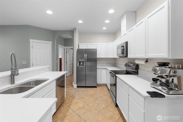 10 Legacy Ln, Elma, WA 98541 - kitchen with appliances with stainless steel finishes, white cabinets, arched walkways, light tile patterned flooring, and recessed lighting