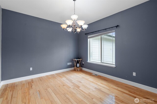 10 Legacy Ln, Elma, WA 98541 - spare room with a chandelier and wood-type flooring