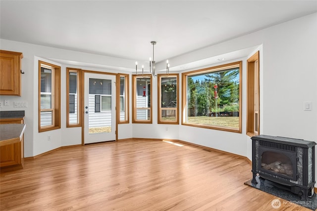 7104 84th St E, Puyallup, WA 98371 - unfurnished dining area with a wood stove and light wood-style floors