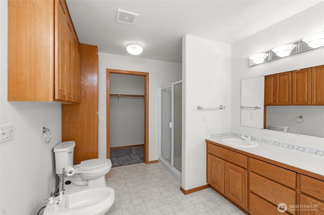 7104 84th St E, Puyallup, WA 98371 - bathroom with a bidet, a shower stall, vanity, and tile patterned floors