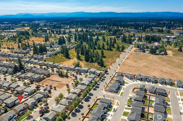 15230 Kayla St SE, Yelm, WA 98597 - aerial overview of property's location featuring a mountain backdrop and nearby suburban area