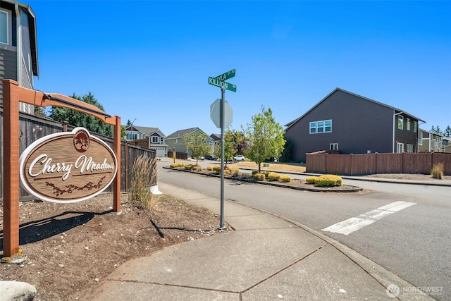 15230 Kayla St SE, Yelm, WA 98597 - view of asphalt street with sidewalks, curbs, traffic signs, and a residential view