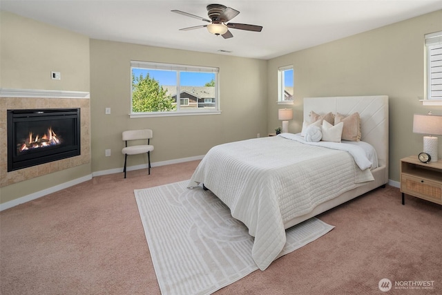 15230 Kayla St SE, Yelm, WA 98597 - bedroom featuring carpet, a tile fireplace, and a ceiling fan