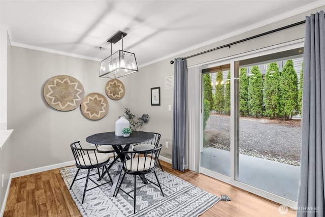 12618 109th Ct NE Unit H102, Kirkland, WA 98034 - dining area featuring ornamental molding, light wood finished floors, and a chandelier