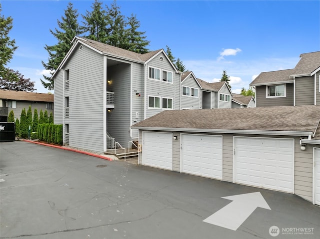 12618 109th Ct NE Unit H102, Kirkland, WA 98034 - view of front of house featuring community garages and a residential view