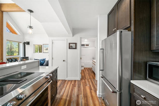 18725 River Rd, Leavenworth, WA 98826 - kitchen featuring stainless steel appliances, light wood-type flooring, dark brown cabinets, decorative light fixtures, and light countertops
