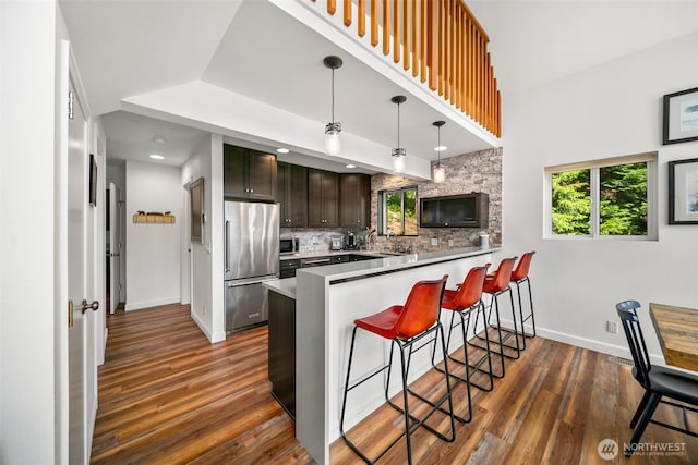 18725 River Rd, Leavenworth, WA 98826 - kitchen with stainless steel appliances, healthy amount of natural light, a peninsula, and a kitchen breakfast bar