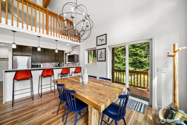 18725 River Rd, Leavenworth, WA 98826 - dining room featuring a high ceiling, light wood-style flooring, and a chandelier