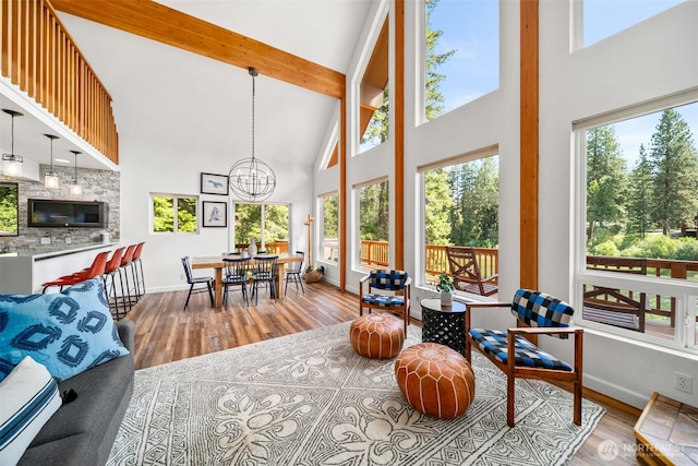 18725 River Rd, Leavenworth, WA 98826 - living room with high vaulted ceiling, a chandelier, healthy amount of natural light, wood finished floors, and beam ceiling