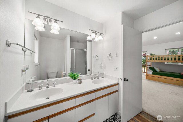 18725 River Rd, Leavenworth, WA 98826 - full bathroom with double vanity, a shower stall, wood finished floors, and recessed lighting