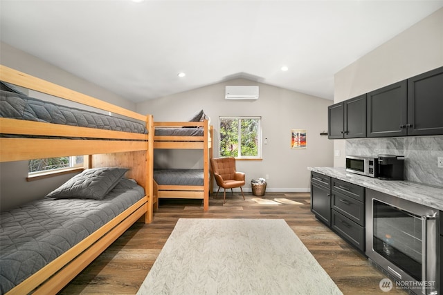 18725 River Rd, Leavenworth, WA 98826 - bedroom with wine cooler, a wall mounted AC, vaulted ceiling, dark wood finished floors, and recessed lighting
