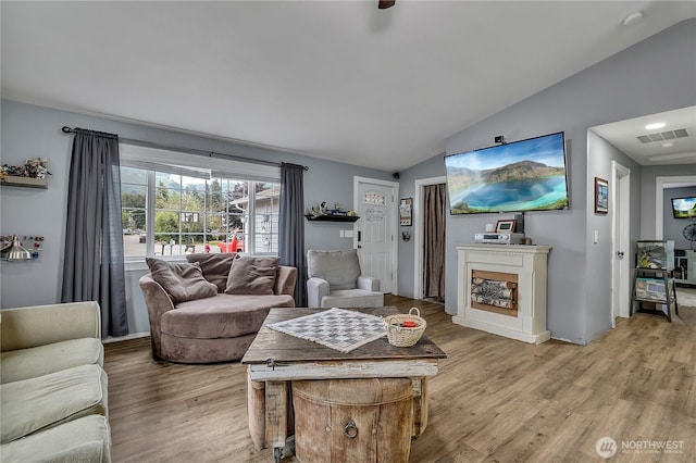 223 Nugget Rd, Gold Bar, WA 98251 - living area featuring lofted ceiling, light wood finished floors, and a fireplace