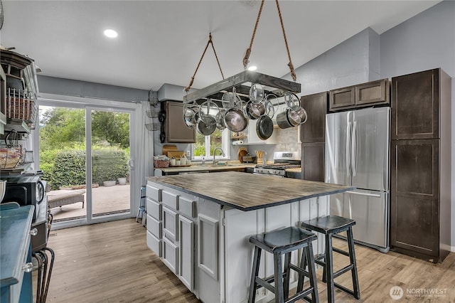 223 Nugget Rd, Gold Bar, WA 98251 - kitchen with stainless steel appliances, butcher block counters, lofted ceiling, light wood-type flooring, and a center island