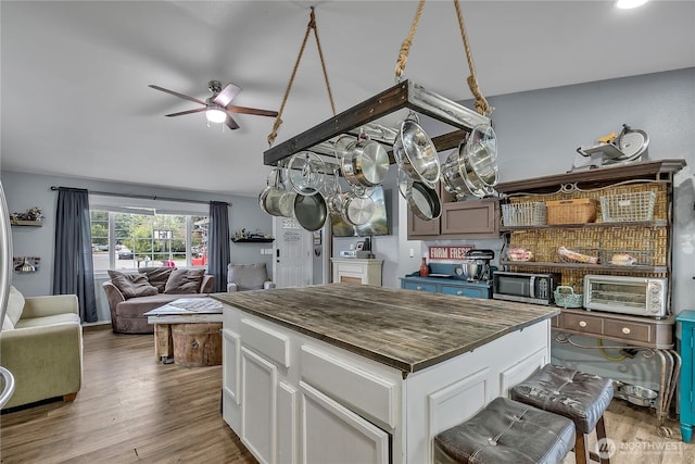 223 Nugget Rd, Gold Bar, WA 98251 - kitchen with stainless steel microwave, a ceiling fan, butcher block countertops, open floor plan, and light wood finished floors
