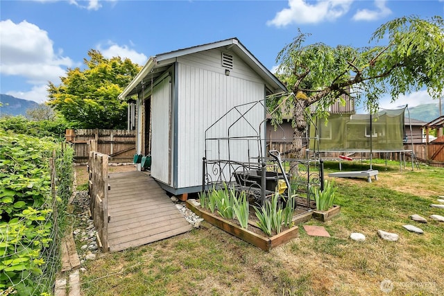 223 Nugget Rd, Gold Bar, WA 98251 - view of outbuilding with a trampoline and a fenced backyard