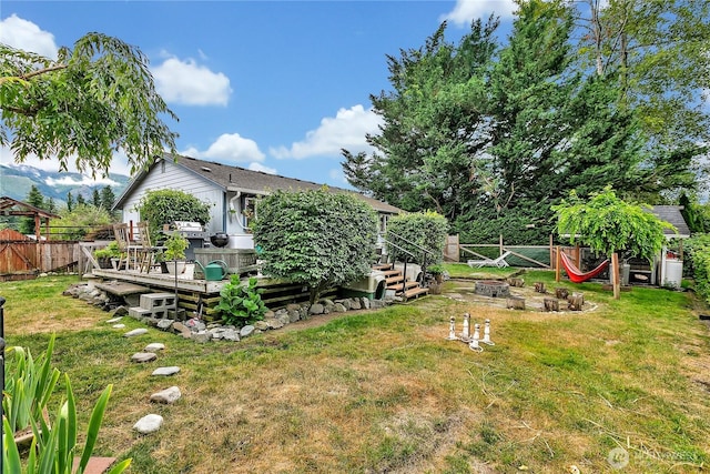 223 Nugget Rd, Gold Bar, WA 98251 - fenced backyard featuring a wooden deck and an outdoor fire pit
