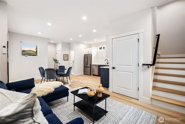 9692 51st Ave S, Seattle, WA 98118 - living room featuring stairs, light wood-type flooring, recessed lighting, and plenty of natural light