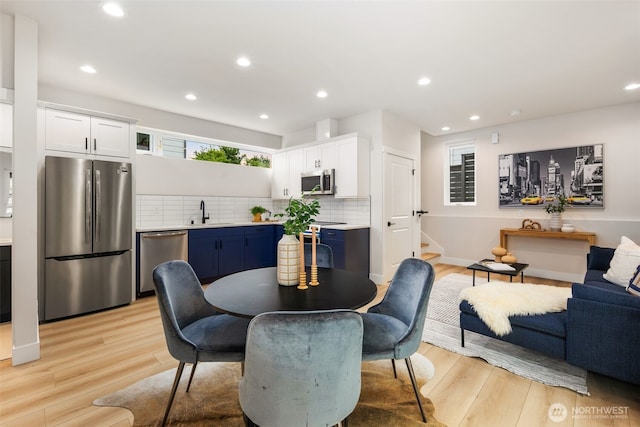 9692 51st Ave S, Seattle, WA 98118 - dining space featuring stairs, light wood finished floors, and recessed lighting