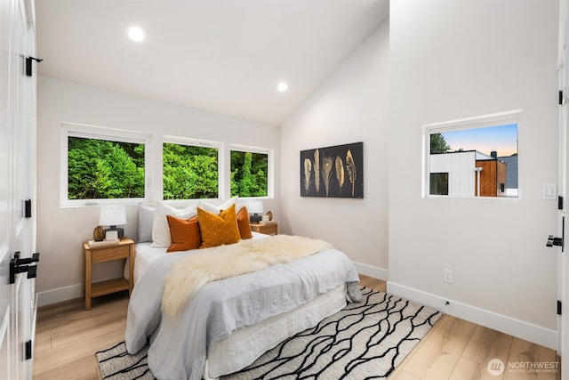 9692 51st Ave S, Seattle, WA 98118 - bedroom with multiple windows, recessed lighting, light wood-style flooring, and high vaulted ceiling
