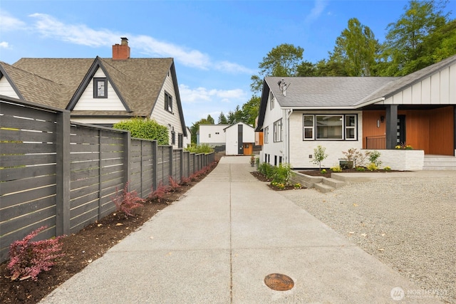9692 51st Ave S, Seattle, WA 98118 - view of side of home with a shingled roof