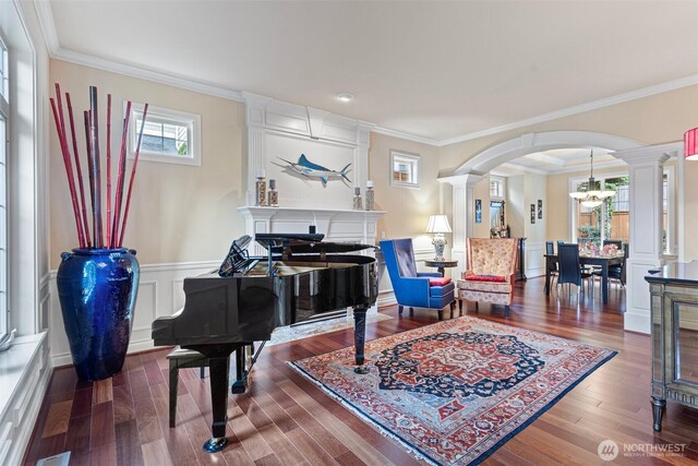 4569 162nd Ln SE, Bellevue, WA 98006 - sitting room with arched walkways, decorative columns, a chandelier, crown molding, and a glass covered fireplace