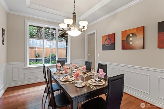4569 162nd Ln SE, Bellevue, WA 98006 - dining room featuring light wood-style flooring, healthy amount of natural light, a chandelier, a wainscoted wall, and ornamental molding