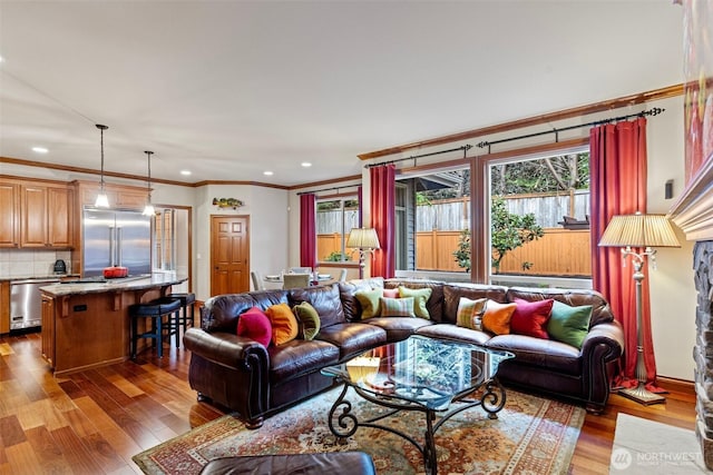 4569 162nd Ln SE, Bellevue, WA 98006 - living room featuring wood finished floors, ornamental molding, and recessed lighting