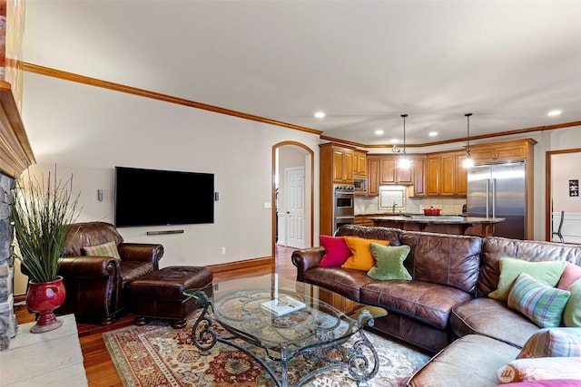 4569 162nd Ln SE, Bellevue, WA 98006 - living room featuring recessed lighting, wood finished floors, crown molding, and arched walkways