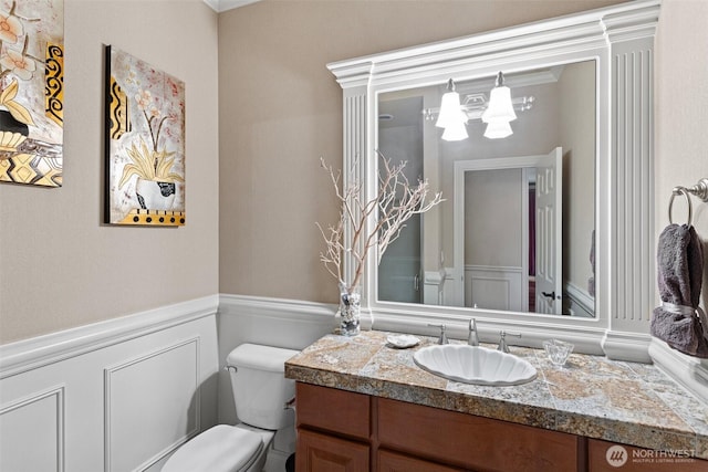4569 162nd Ln SE, Bellevue, WA 98006 - bathroom with vanity, a chandelier, wainscoting, a decorative wall, and crown molding