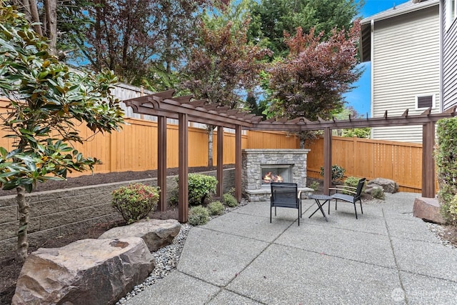 4569 162nd Ln SE, Bellevue, WA 98006 - fenced backyard featuring an outdoor stone fireplace, a patio area, and a pergola