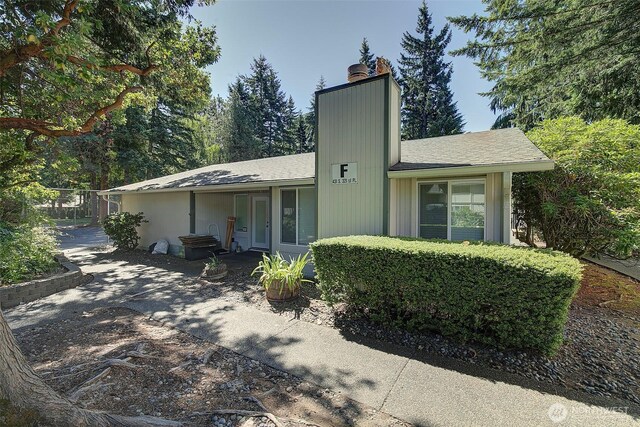 421 S 321st Pl Unit C4, Federal Way, WA 98003 - view of front facade featuring a chimney and a shingled roof