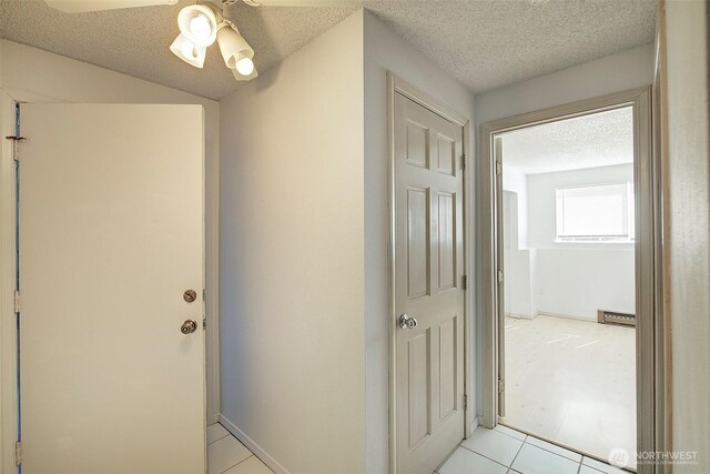 421 S 321st Pl Unit C4, Federal Way, WA 98003 - corridor featuring a textured ceiling and light tile patterned flooring