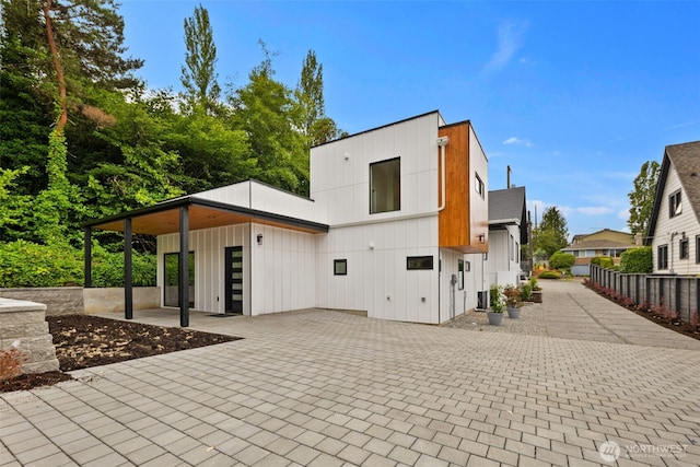 9694 51st Ave S, Seattle, WA 98118 - view of front of home featuring board and batten siding and a patio area