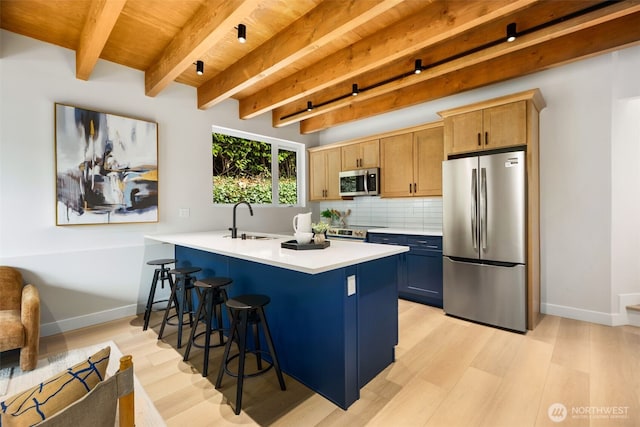 9694 51st Ave S, Seattle, WA 98118 - kitchen featuring stainless steel appliances, a kitchen breakfast bar, light wood-type flooring, light countertops, and a wood ceiling with exposed beams