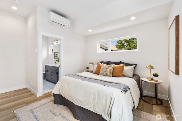 9694 51st Ave S, Seattle, WA 98118 - bedroom featuring an AC wall unit, light wood-type flooring, recessed lighting, and ensuite bath