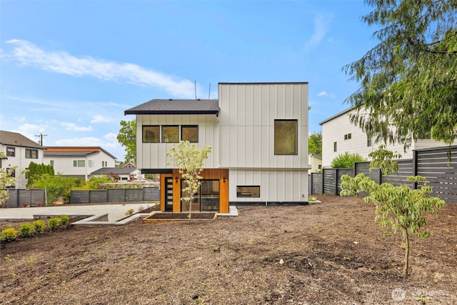 9694 51st Ave S, Seattle, WA 98118 - back of property with board and batten siding and a fenced backyard