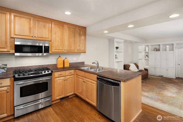 1732 Bellevue Way NE, Bellevue, WA 98004 - kitchen with stainless steel appliances, dark countertops, a peninsula, open floor plan, and recessed lighting