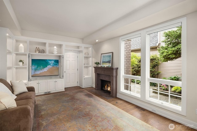 1732 Bellevue Way NE, Bellevue, WA 98004 - living area with a fireplace with flush hearth, wood finished floors, and built in shelves