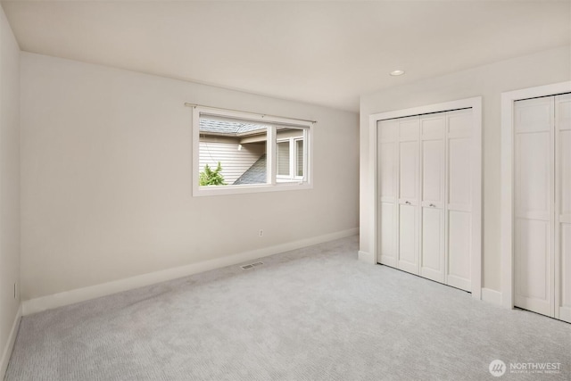 1732 Bellevue Way NE, Bellevue, WA 98004 - unfurnished bedroom featuring carpet floors, two closets, and recessed lighting