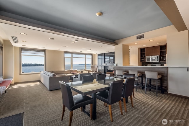 2607 Western Ave Unit 655, Seattle, WA 98121 - carpeted dining space with a water view, healthy amount of natural light, and recessed lighting