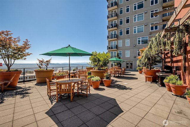 2607 Western Ave Unit 655, Seattle, WA 98121 - view of patio featuring outdoor dining space and a water view