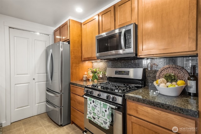 2607 Western Ave Unit 655, Seattle, WA 98121 - kitchen featuring appliances with stainless steel finishes, brown cabinetry, light tile patterned floors, tasteful backsplash, and recessed lighting