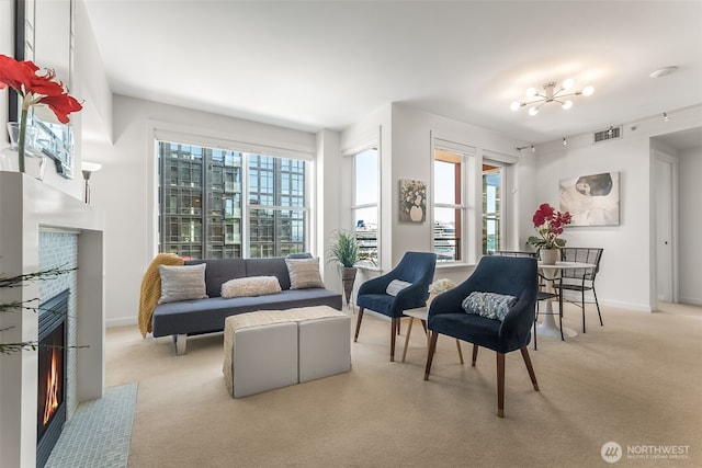 2607 Western Ave Unit 655, Seattle, WA 98121 - living area featuring a warm lit fireplace, light carpet, plenty of natural light, and a chandelier