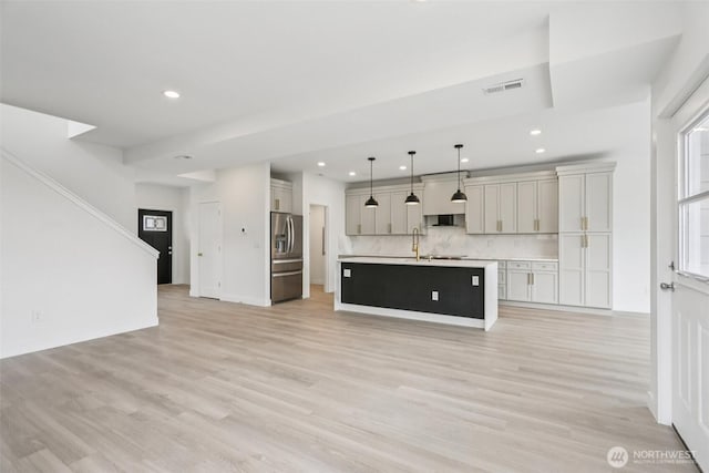 3102 44th Ave NE, Tacoma, WA 98422 - kitchen featuring stainless steel fridge, open floor plan, recessed lighting, light wood-style flooring, and light countertops