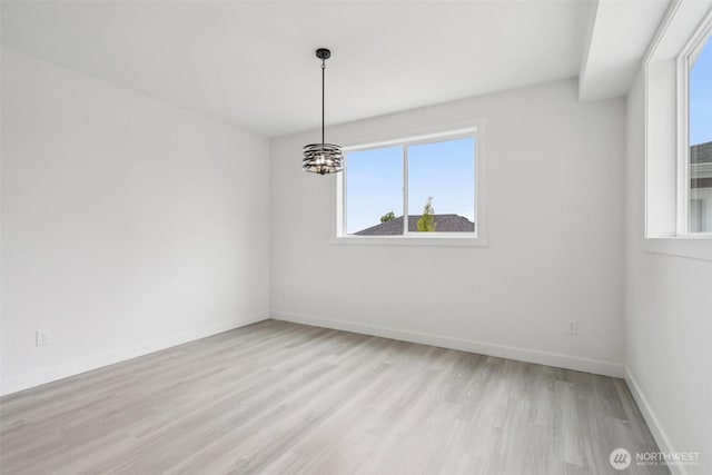 3102 44th Ave NE, Tacoma, WA 98422 - spare room featuring light wood-type flooring and a chandelier