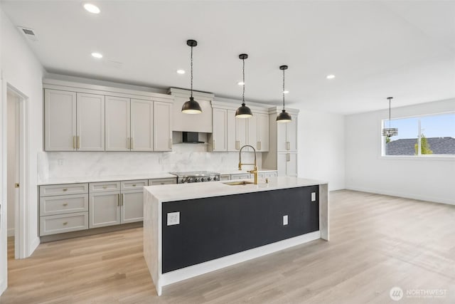 3102 44th Ave NE, Tacoma, WA 98422 - kitchen with tasteful backsplash, light countertops, gray cabinetry, light wood-type flooring, and recessed lighting